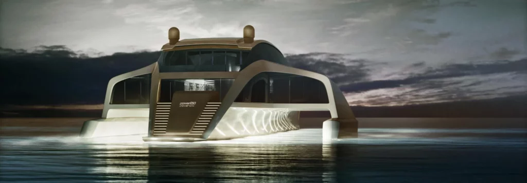 Der 210 Sunreef Power Trimaran bei Nacht, beleuchtet und auf ruhigem Wasser. Die Beleuchtung unterstreicht die elegante und innovative Architektur des Trimarans.