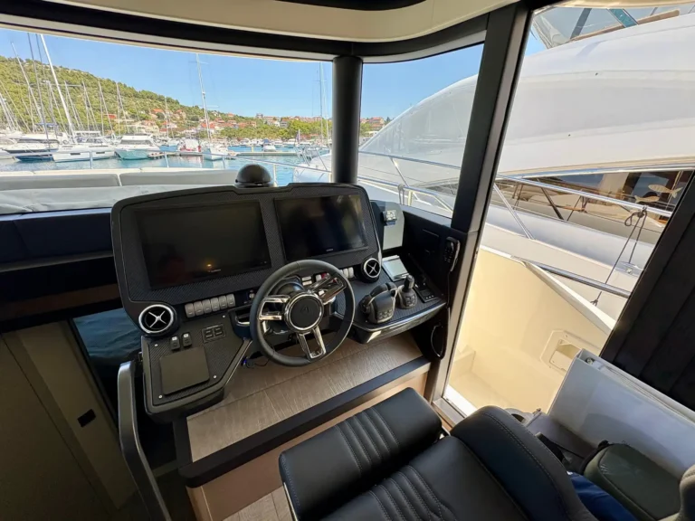 Helm station with two large displays and a modern navigation system on the Absolute Navetta 52.